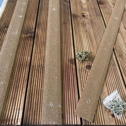 Brown anti-slip strips screwed onto outdoor wooden steps