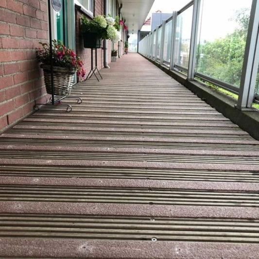 Brown anti-slip strips installed across a timber balcony walkway